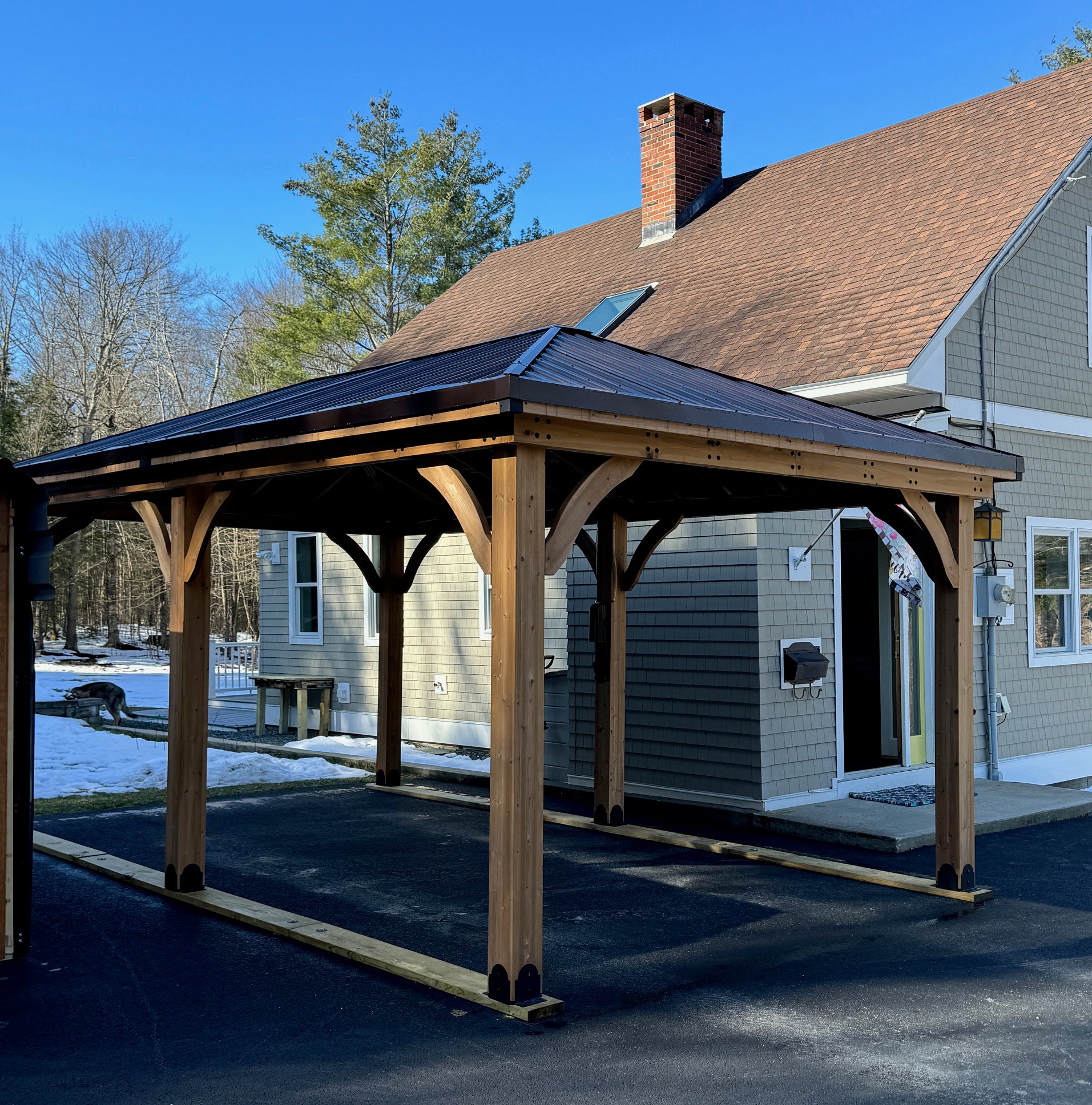 Wooden carport installation with asphalt anchors