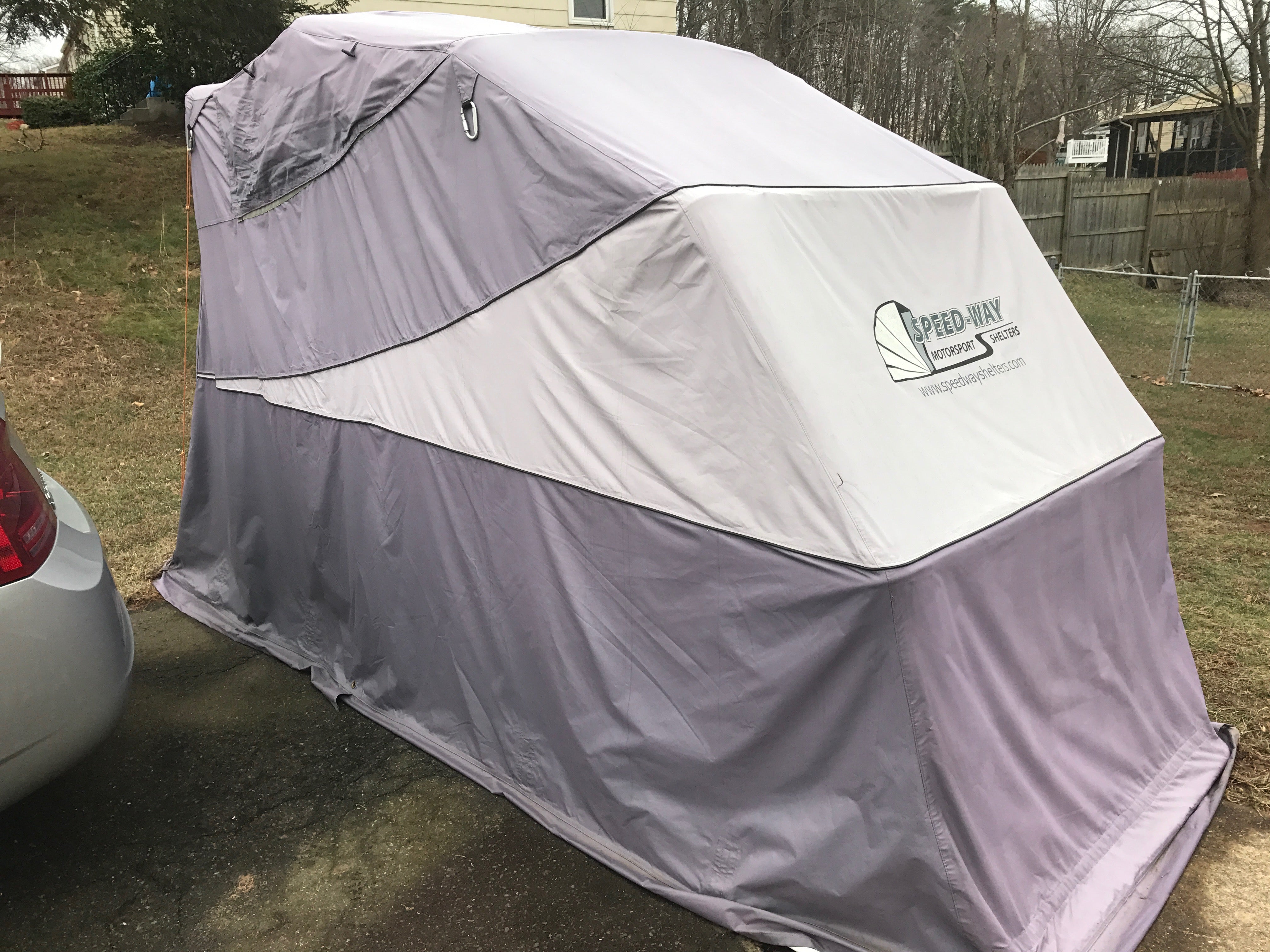 Motorcycle shelter with asphalt anchors